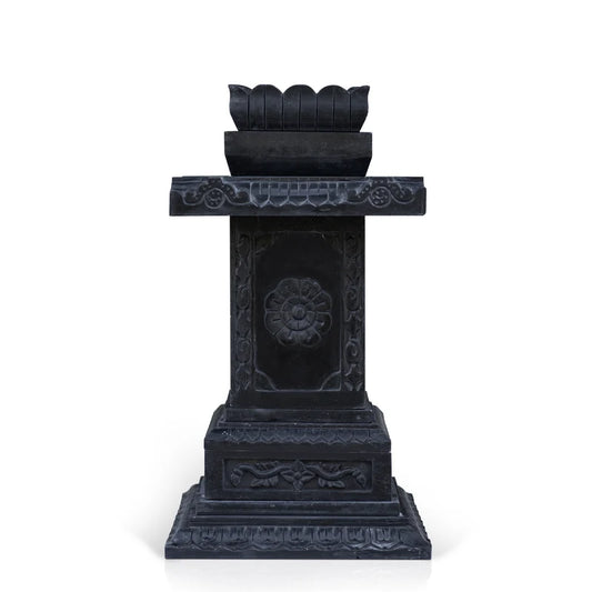 Close-up of intricate traditional stone carvings on black marble Tulsi planter