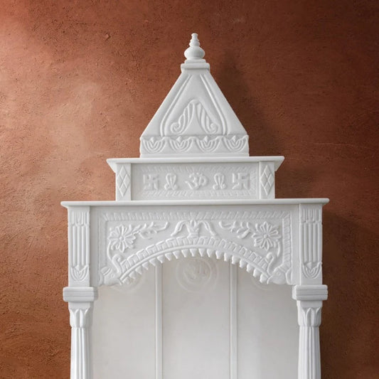 Side carved pillars and architectural detail of pure white marble home mandir