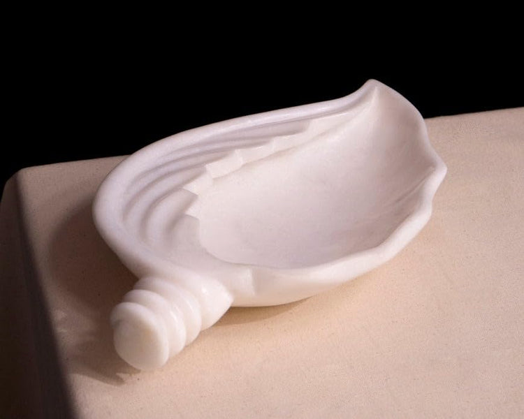 Exquisite handcrafted marble urli bowl decorated with floating flowers for home interior styling on Rajasthani Duniyaa.