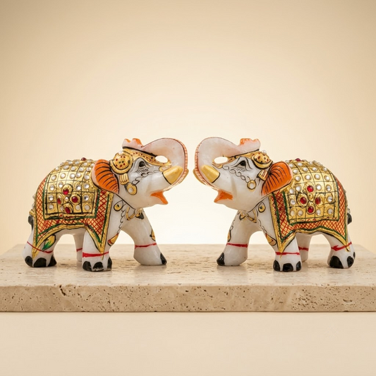 The Royal Ambabari Pair: Hand-Carved Natural White Marble Elephants with Ornate Gold Foil Jhool & Studded Kundan Detailing (Pair of 2)ndcrafted Marble Elephant Pair – Decorative Figurines with Stone & Gold Work