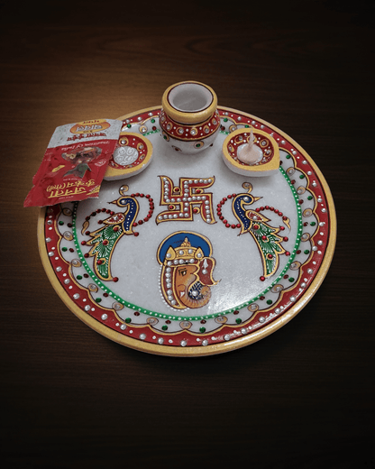Handcrafted 9-inch white marble pooja thali with Ganesh Swastik and peacock motifs