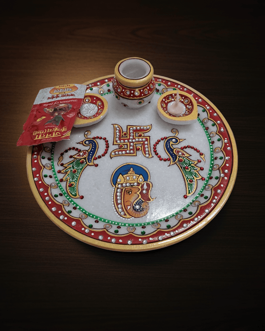 Handcrafted 9-inch white marble pooja thali with Ganesh Swastik and peacock motifs