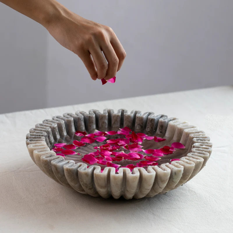 Scalloped marble Urli bowl decorated with floating flowers and candles for home decor