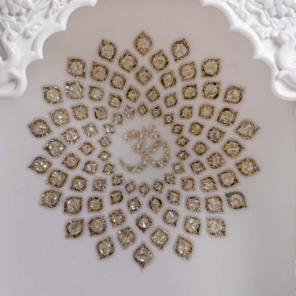 Close-up of golden chakra and carved pillars on marble pooja mandir
