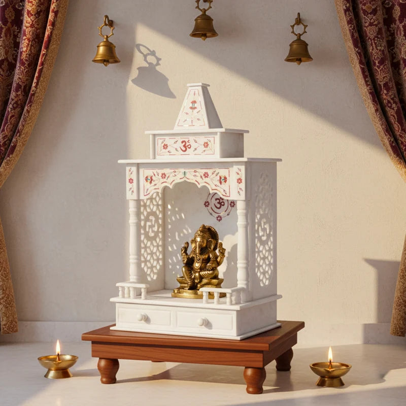 Intricate red inlay stonework and traditional carvings on a premium white marble home mandir
