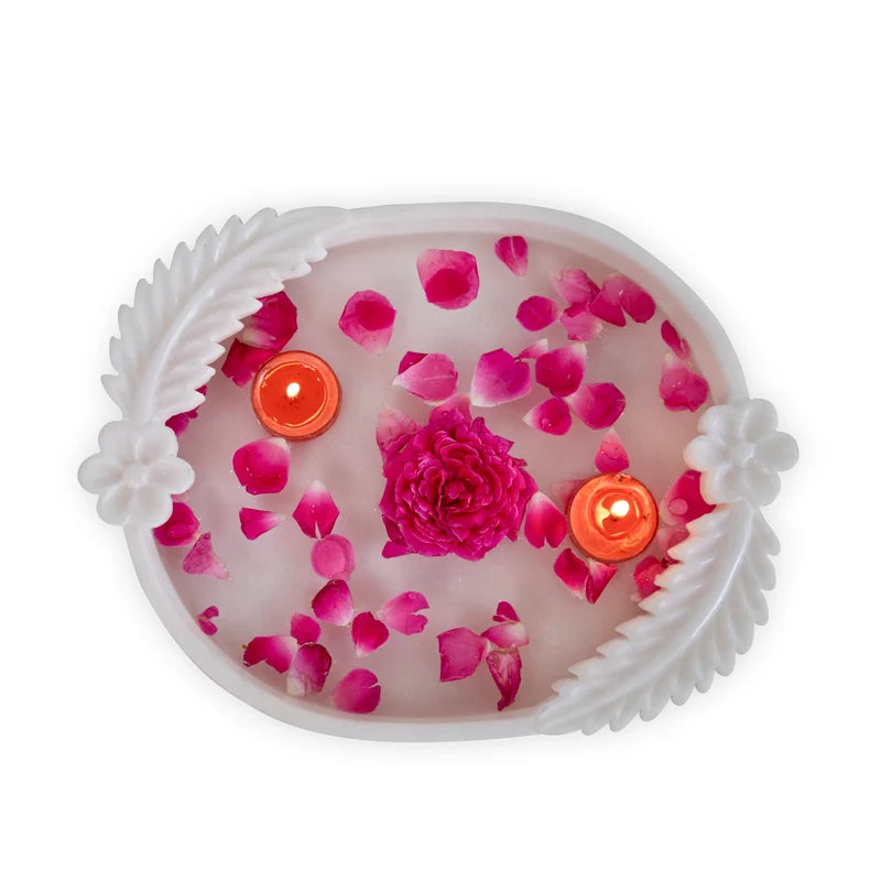 Double leafed white marble Urli bowl decorated with floating flowers and candles for home decor
