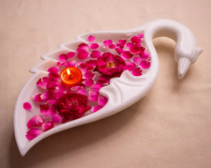 Peacock motif white marble Urli bowl decorated with floating flowers and candles for home decor