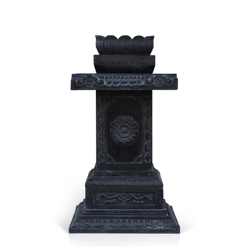 Close-up of intricate traditional stone carvings on black marble Tulsi planter
