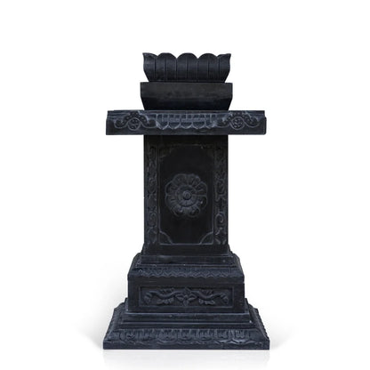 Close-up of intricate traditional stone carvings on black marble Tulsi planter