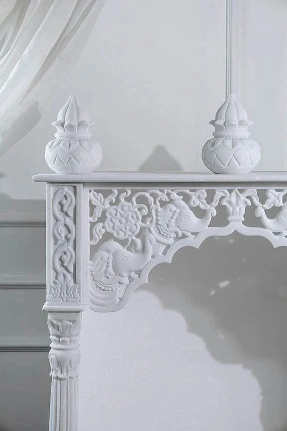 Inner sanctum view of traditional white marble temple with Kalash design