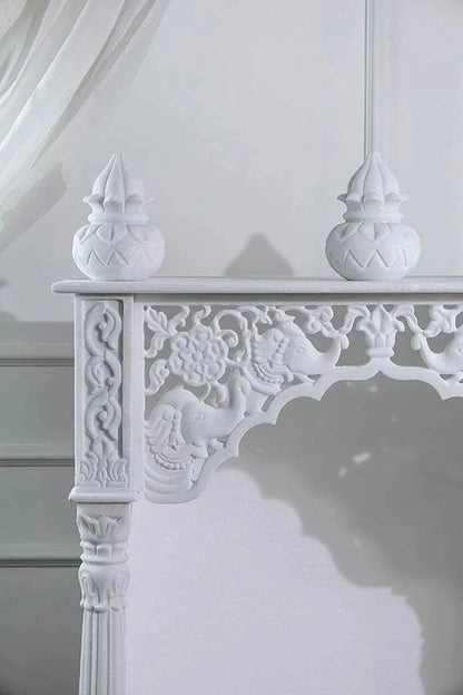 Inner sanctum view of traditional white marble temple with Kalash design