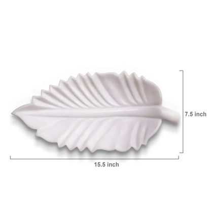 Leaf-shaped white marble Urli bowl decorated with floating flowers and candles for home decor