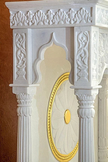 Inner sanctum view of traditional white marble temple with chakra design