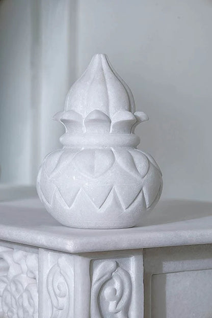 Inner sanctum view of traditional white marble temple with Kalash design