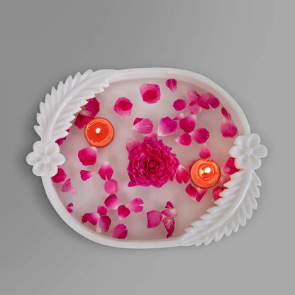 Close-up of carved double leaf motifs and rim on white marble Urli bowl