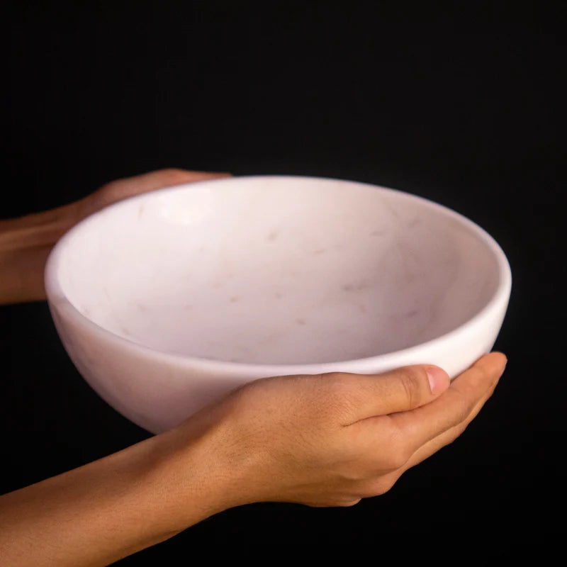 Side profile and depth detail of natural white marble Urli and fruit bowl
