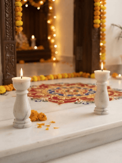 Close-up of smooth carved detailing on a natural white marble pillar deepam