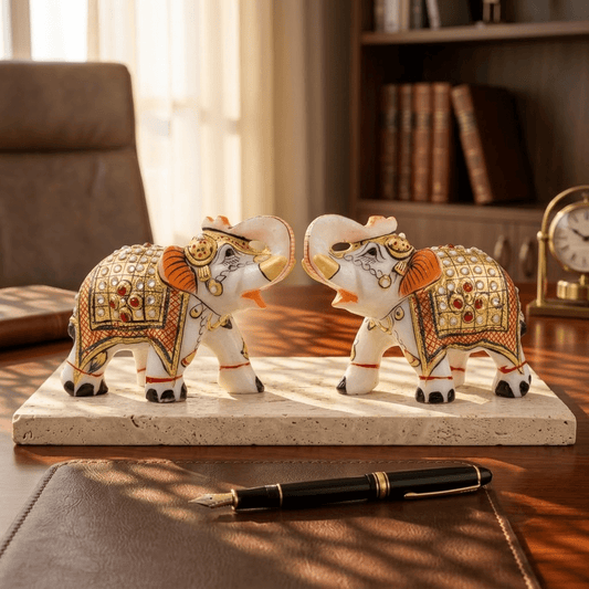 The Royal Ambabari Pair: Hand-Carved Natural White Marble Elephants with Ornate Gold Foil Jhool & Studded Kundan Detailing (Pair of 2)ndcrafted Marble Elephant Pair – Decorative Figurines with Stone & Gold Work - Rajasthaniduniyaa