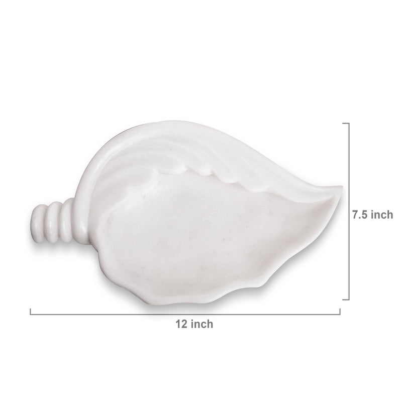 Shell-shaped white marble Urli bowl decorated with floating flowers and candles for home decor